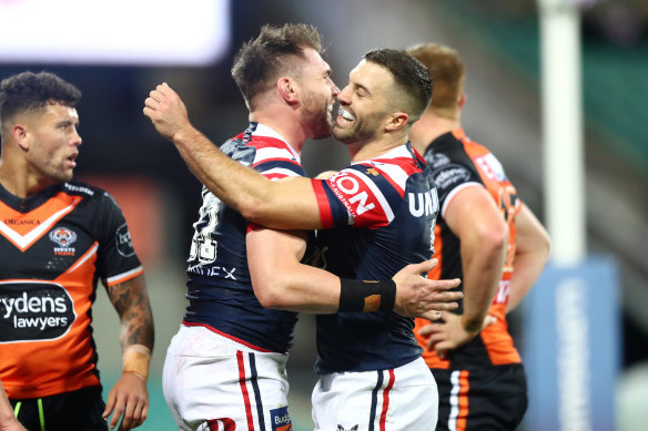 The Roosters celebrate one of their 12 tries against the Tigers.