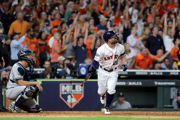 Jose Altuve watches his walk-off homer leave the park.