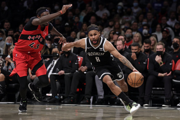 The Nets’ Patty Mills drives to the basket against the Toronto Raptors.