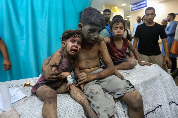 Palestinian children injured in Israeli air raids arrive at Nasser Medical Hospital in Gaza.