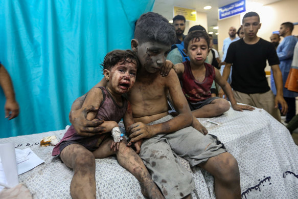 Palestinian children injured in Israeli air raids arrive at Nasser Medical Hospital in Gaza this week.