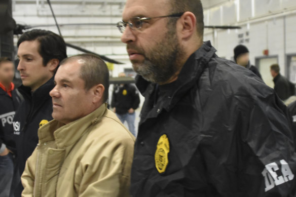 US Drug Enforcement Administration, authorities escort Joaquin "El Chapo" Guzman, centre, from a plane to a waiting caravan of SUVs at Long Island MacArthur Airport in New York in 2017.