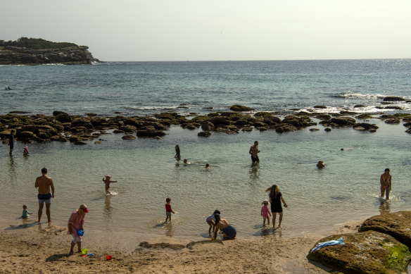 Beachgoers cool off after another sweltering day. 