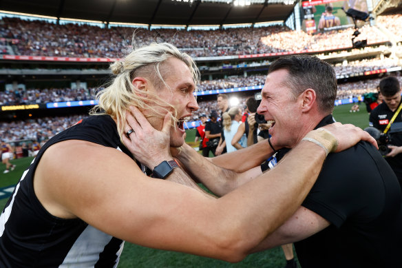 Captain Darcy Moore and coach Craig McRae celebrate Collingwood’s win over Brisbane.