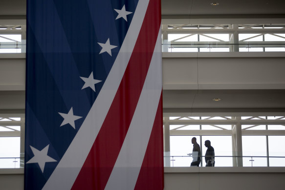 People walk through the atrium of the U.S. Patent and Trademark Office headquarters in Alexandria, Virginia.