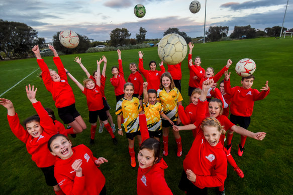 Girls from Barnstoneworth United soccer club in Melbourne celebrate after Australia and New Zealand were selected to host the 2023 FIFA Women’s World Cup.