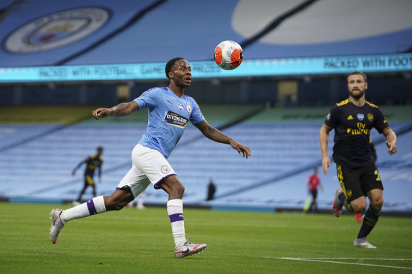 Manchester City's Raheem Sterling scores the opening goal during the English Premier League soccer match between Manchester City and Arsenal.