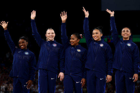 Gold medalists Simone Biles, Jade Carey, Jordan Chiles, Sunisa Lee and Hezly Rivera of Team United States celebrate on the podium during the medal ceremony.