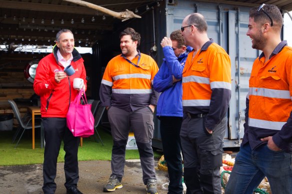 Port Authority of NSW CEO Captain Philip Holliday (left) with the crew of Engage Marine following the MV Portland Bay rescue in July 2022. The Engage Marine crew lost all their crockery in the storm.