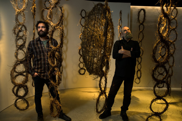 Linear exhibition designer Jacob Nash and curator Marcus Hughes, with artist Vicki West's work, Milaythina Takila (heart country), at the Powerhouse in Sydney.
