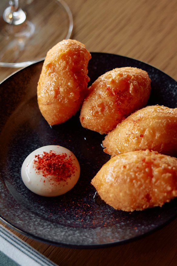 Smoked cheddar puffs with hot honey at 81 Bay.
