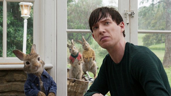 Domhnall Gleeson with Peter Rabbit, voiced by James Corden, in Peter Rabbit.