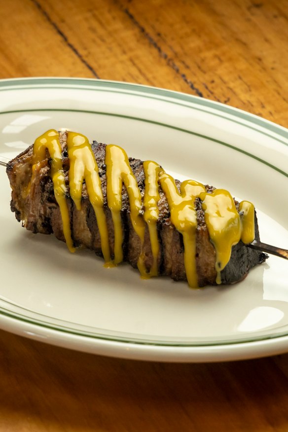 Lamb belly is slow-cooked, pressed into a skewer, then flame-licked to order.
