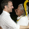 French President Emmanuel Macron, left, embraces Chief Raoni Metuktire after presenting him with the French distinction, the Legion of Honor.