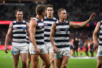 Leading Geelong players leave the field after the loss.