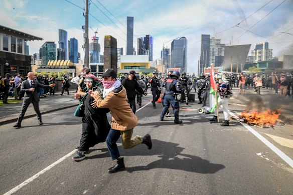 Protesters flee after a fire is started.