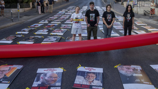Families and friends of hostages held by Hamas in Gaza display 107 pictures of hostages as they protest outside the Prime Minister Benjamin Netanyahu’s residence in Jerusalem.