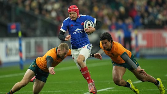 France’s Louis Bielle-Biarrey, center, runs with the ball during the rugby union Nations Series match between France and Australia in Saint-Denis, outside Paris, Saturday, Nov. 22, 2025. (AP Photo/Christophe Ena)