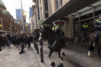 Mounted police were pelted with bottle and flower pots during the anti-lockdown protest in Sydney on Saturday.