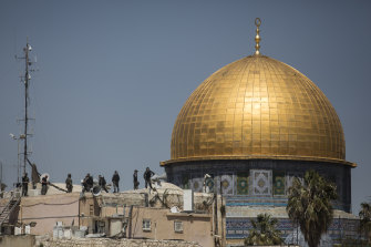 Israeli police stand on a rooftop near Al-Aqsa mosque.