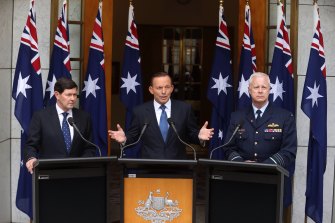 Former Defence Minister Kevin Andrews (L), with then-prime minister Tony Abbott in 2015 announcing preparation for a troop deployment to Iraq. 
