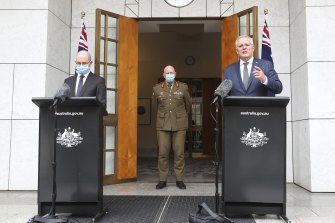 Chief Medical Officer Professor Paul Kelly (left) reiterated Omicron was a milder strain, while Prime Minister Scott Morrison (right) said Omicron had taken him by surprise.