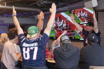 Fans enjoy the Super Bowl in Darling Harbour on Monday.
