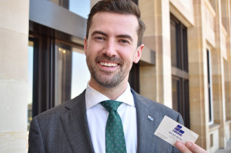 New opposition leader Zak Kirkup with the same type of business card he once handed to Prime Minister John Howard.