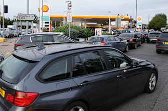 Drivers queue for fuel at a petrol station in London on Tuesday. Long lines of vehicles have formed at many gas stations around Britain since Friday, causing spillover traffic jams on busy roads.