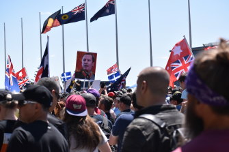 Protesters hold a sign depicting WA Premier Mark McGowan as Joseph Stalin during an anti-mandate rally at Parliament House in Perth on December 1.