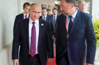 Russian President Vladimir Putin, left, and Russian metals magnate Oleg Deripaska, right.