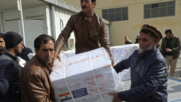 Afghan health ministry workers unload boxes of the first shipment of 500,000 doses of the AstraZeneca coronavirus vaccine made by Serum Institute of India.