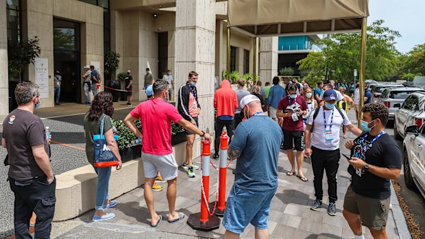 People associated with the Australian Open line up at a testing facility at the View Hotel in Melbourne. 