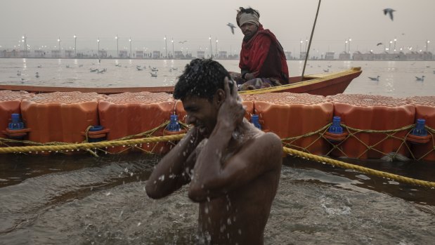 An Indian Hindu devotee takes a holy dip at Sangam.