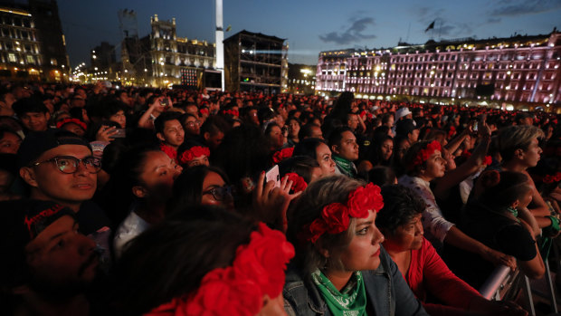 Spectators look on as French-Chilean singer Ana Tijoux performs during a concert by female artists on the eve of International Women's Day, in the Zocalo in Mexico City.