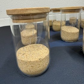 The jars of Bondi Beach sand sprinkled by Roosters players on the  Accor Stadium turf before the grand final.