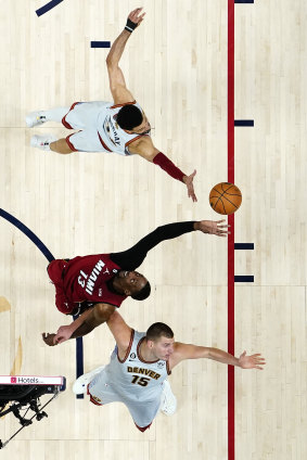 Bam Adebayo of the Miami Heat battles Jamal Murray and Nikola Jokic. 