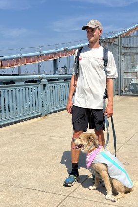 Tom Turcich and Savannah cross the Benjamin Franklin Bridge on the last leg of their seven-year adventure.