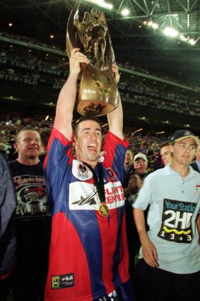Andrew Johns holding aloft the 2001 premiership trophy is one of several enduring images of the great halfback.
