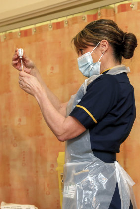 A nurse prepares a dose of the AstraZeneca COVID-19 vaccine in Oxford, England, last month.