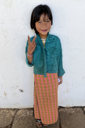 A Bhutanese girl poses happily. 