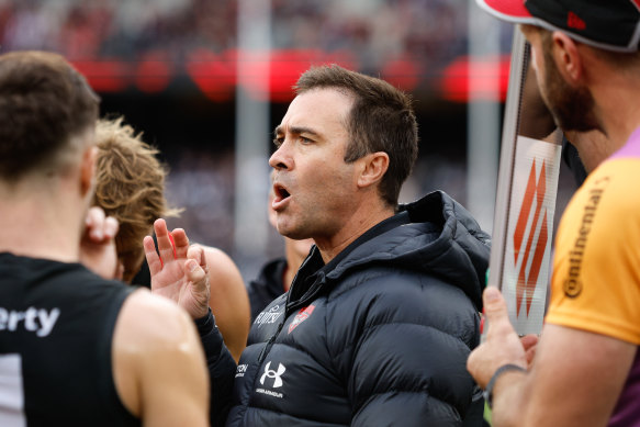 Brad Scott addresses his players during Essendon’s Anzac Day clash with Collingwood.