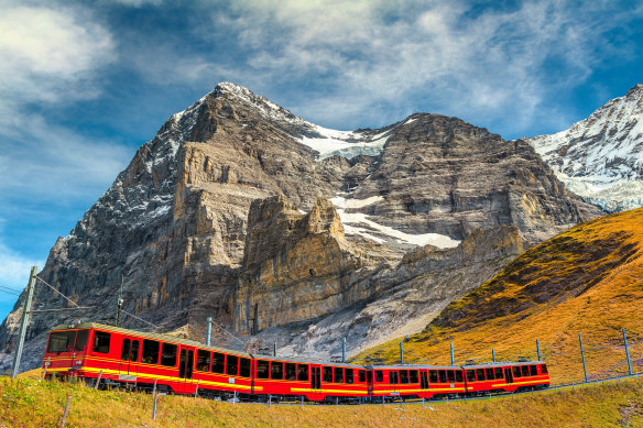 A tourist train travels down the mountain from Jungfraujoch station.