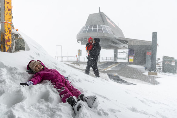 The ski season will finally begin on Tuesday after a cold front brought a large dumping of snow to Thredbo. Sam and Kristie Lau-Adams spent Sunday morning enjoying the  falls with their daughter Goldie and son Iggy.