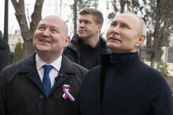 Russian President Vladimir Putin (right) and Governor of Sevastopol Mikhail Razvozhayev visit the Children’s Art and Aesthetic centre in Sevastopol, Crimea on Saturday.