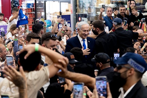 Benjamin Netanyahu greets supporters during a campaign event at a mall ahead of Israel’s legislative elections on October 27, 2026.