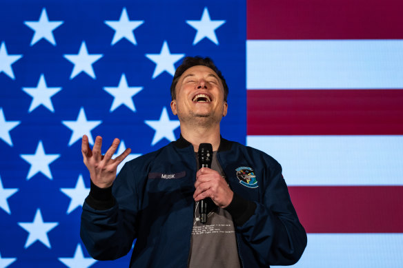 Elon Musk at a rally for Donald Trump. His investment will be rewarded.