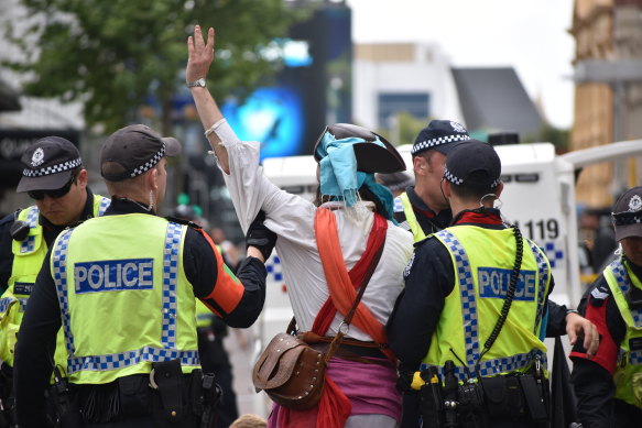 Extinction Rebellion protesters are arrested by police after a sit-in at the intersection of Hay Street and William Street in the Perth CBD. 