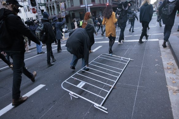 Protesters use items found on the side of the road to block traffic as they move through the CBD.  The Herald does not suggest that any of the people photographed were among those arrested, or that they have broken the law or engaged in wrongdoing.