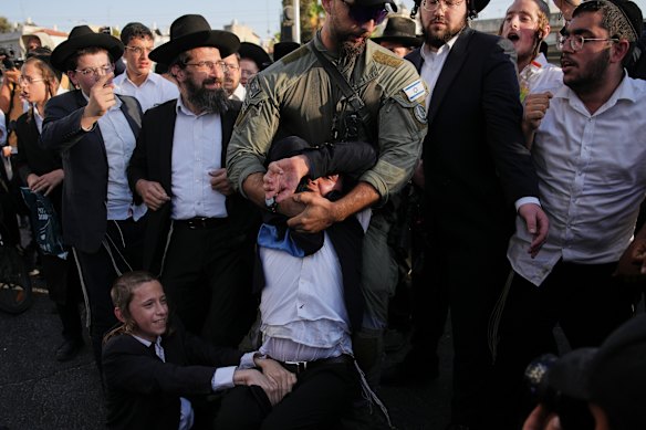 Police break up an ultra-Orthodox  protest in Bnei Brak on August 19.